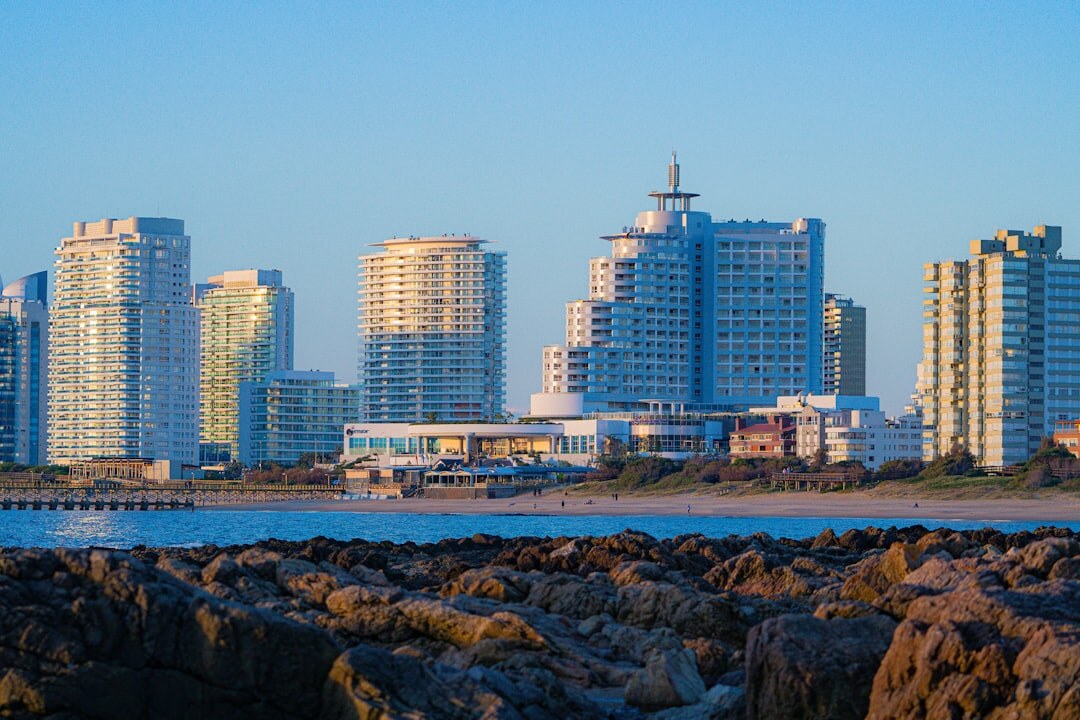 Skyline of Punta del Este peninsula with high-rise towers and marina at dusk