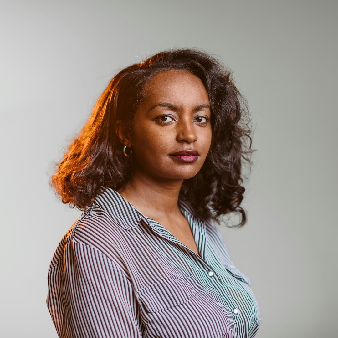 Studio portrait of a Uruguayan woman in her fifties, founder of a boutique real estate agency